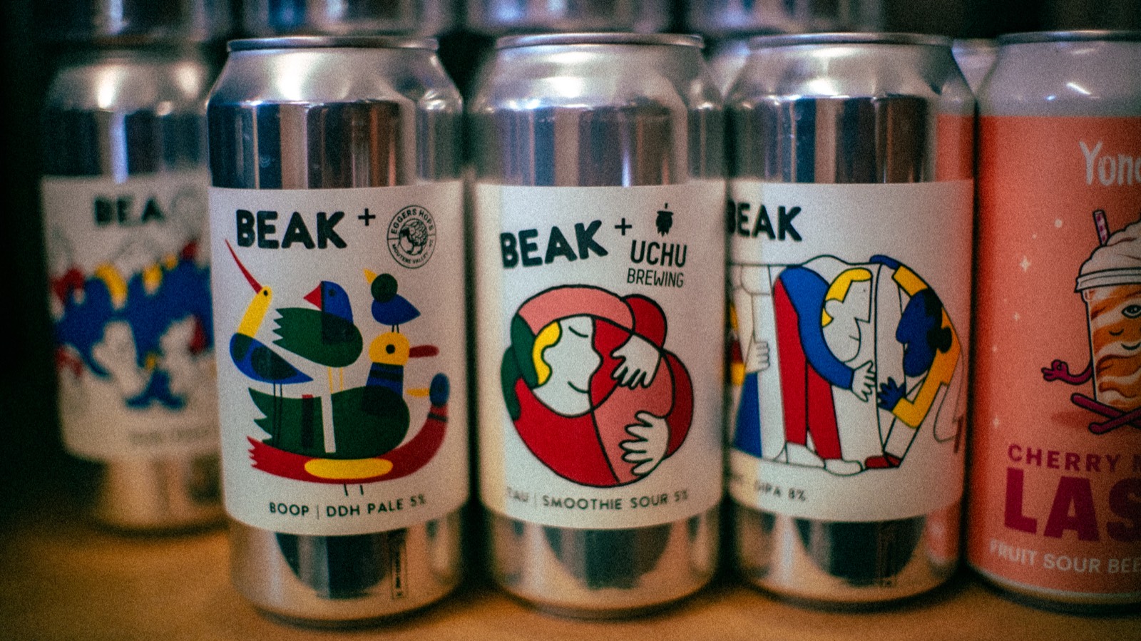Brightly illustrated craft beer cans on the shelf